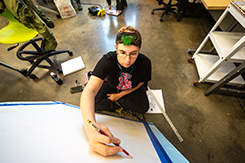 Student works on canvas in Art and Design building lab