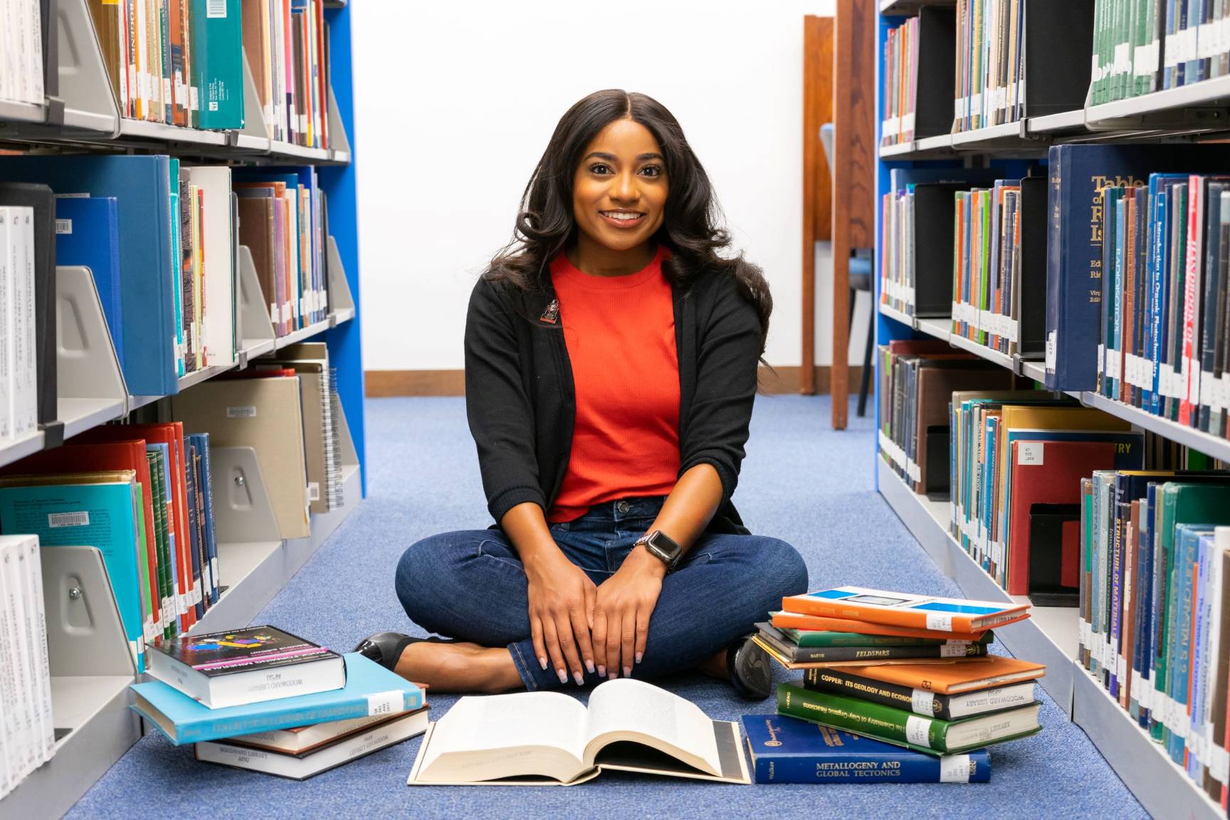 Student poses for photo in library